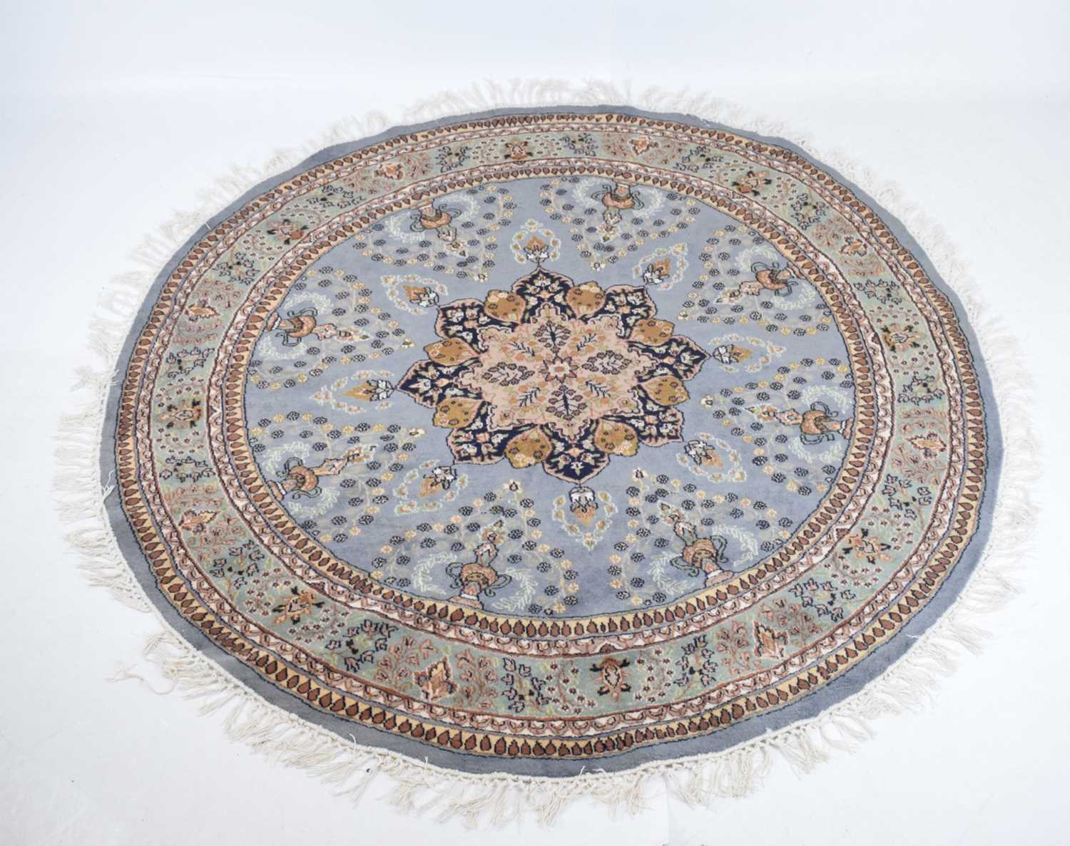 Circular blue ground wool rug with central medallion