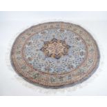 Circular blue ground wool rug with central medallion