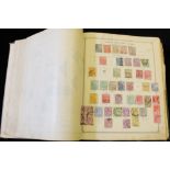 OLD IDEAL ALBUM (rather battered) containing a M & U world collection of over 3600 stamps,