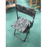 A folding hunting stool (13).