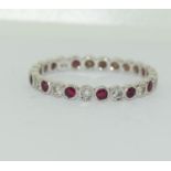 18ct white gold ruby and diamond eternity ring. Size P.