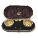 Boxed 3 leg silver salts with scalloped surrounds and matching silver spoons