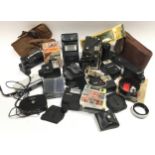 Box of vintage camera accessories to include Cokin filter system, Olympus power winder, Canon