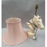 White horse head table lamp with pink shade.