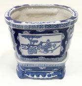 An oriental blue and white planter on blue and white matching base 23cm total height.
