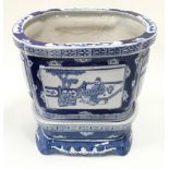 An oriental blue and white planter on blue and white matching base 23cm total height.