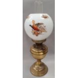Brass oil lamp with flue and pheasant globe.