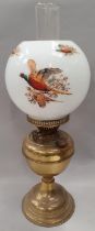 Brass oil lamp with flue and pheasant globe.