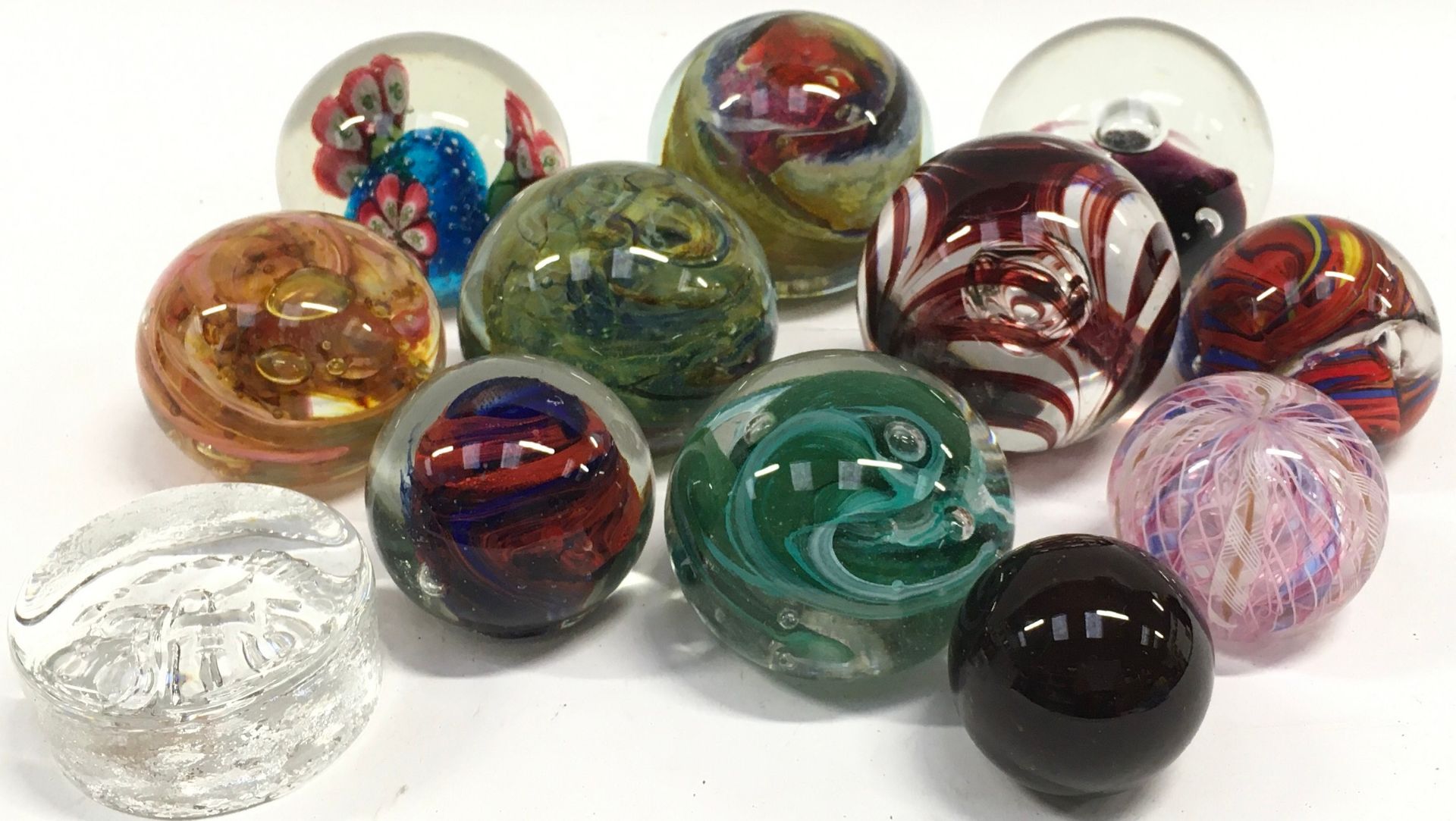 Collection of glass paperweights to include examples by Langham and Caithness