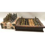 2 vintage chess sets. One metal based oriental figures boxed and the second in brass and silvered