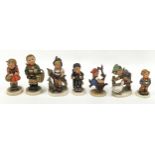 A collection of seven Hummel/Goebel figurines.