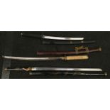 Three decorative samurai swords.