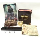 Collection of Harry Potter items to include a trivia game and a boxed wand