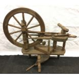 A vintage wooden spinning wheel.