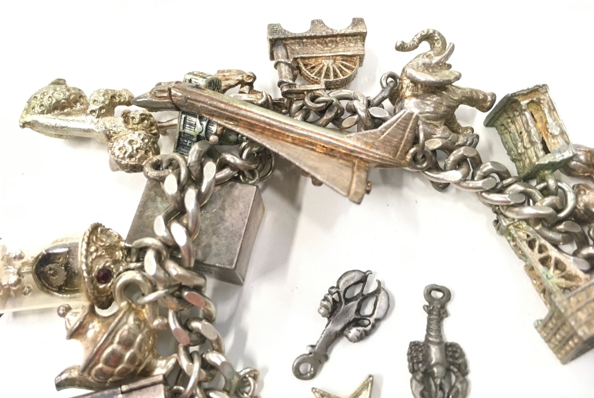 Silver charm bracelet with a large collection of charms. - Image 2 of 4