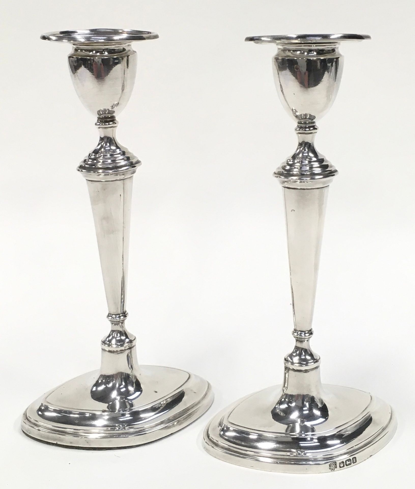 A pair of sterling silver hallmarked candlesticks each 18.5cm tall.