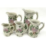 Five graduated Victoria Ironstone Staffordshire jugs.