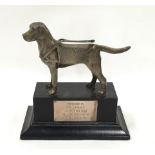A guide dogs trophy with model of a dog to top.