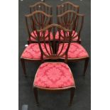 Set of five shield back dining chairs with red upholstered seat pads.