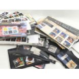 large collection of first day covers, presentation packs and loose stamps in a biscuit box. Many