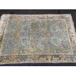 Large blue room size rug displaying birds and animals set with a dark blue border 320x230cm some