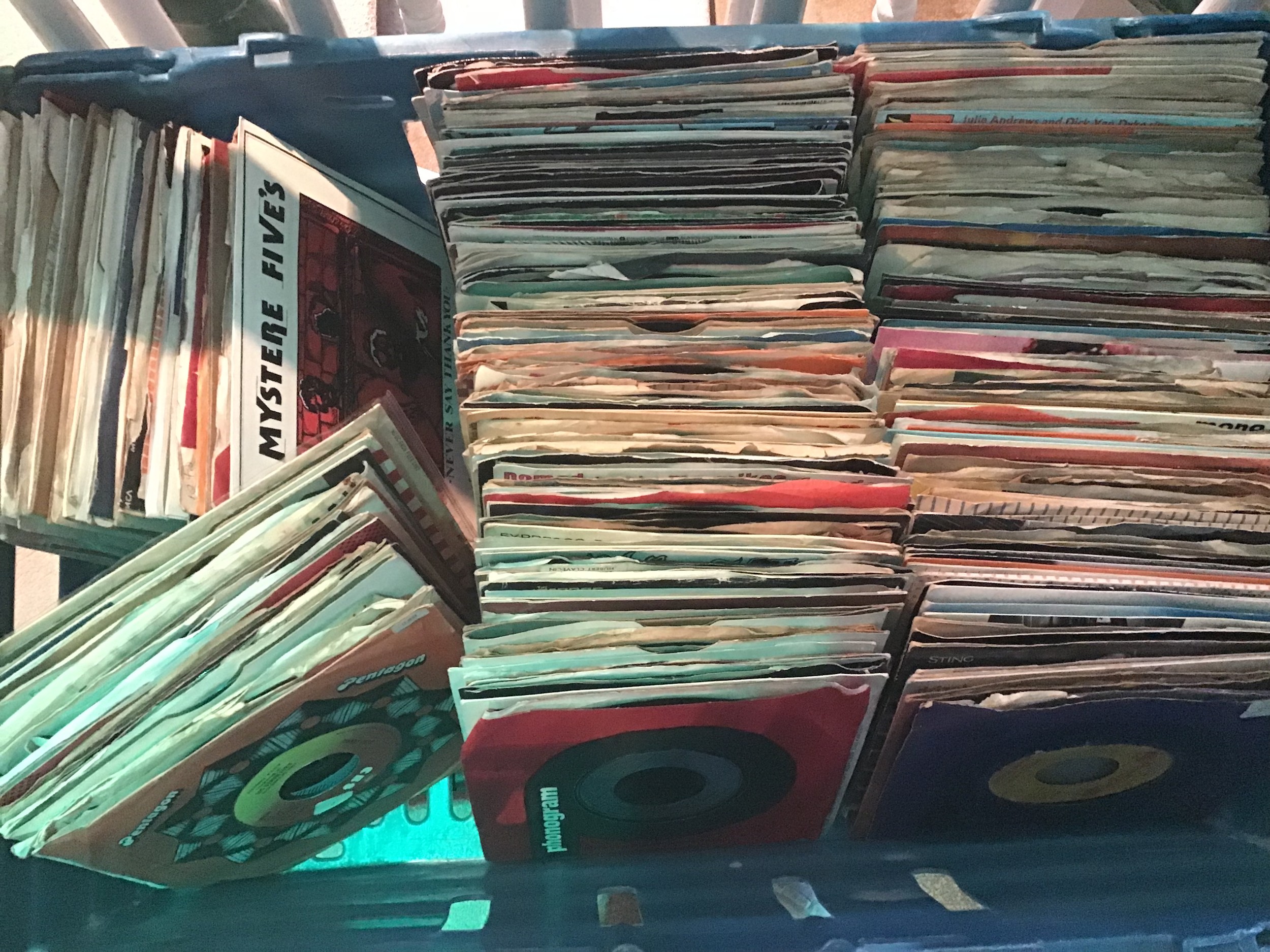 Large box of various 7" single records.