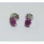 A pair of natural ruby accent diamond 925 silver earrings