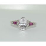 18ct white gold ring, centre oval pink Kunzite in a 4 claw setting, with 3 ruby tapers and 6 pave