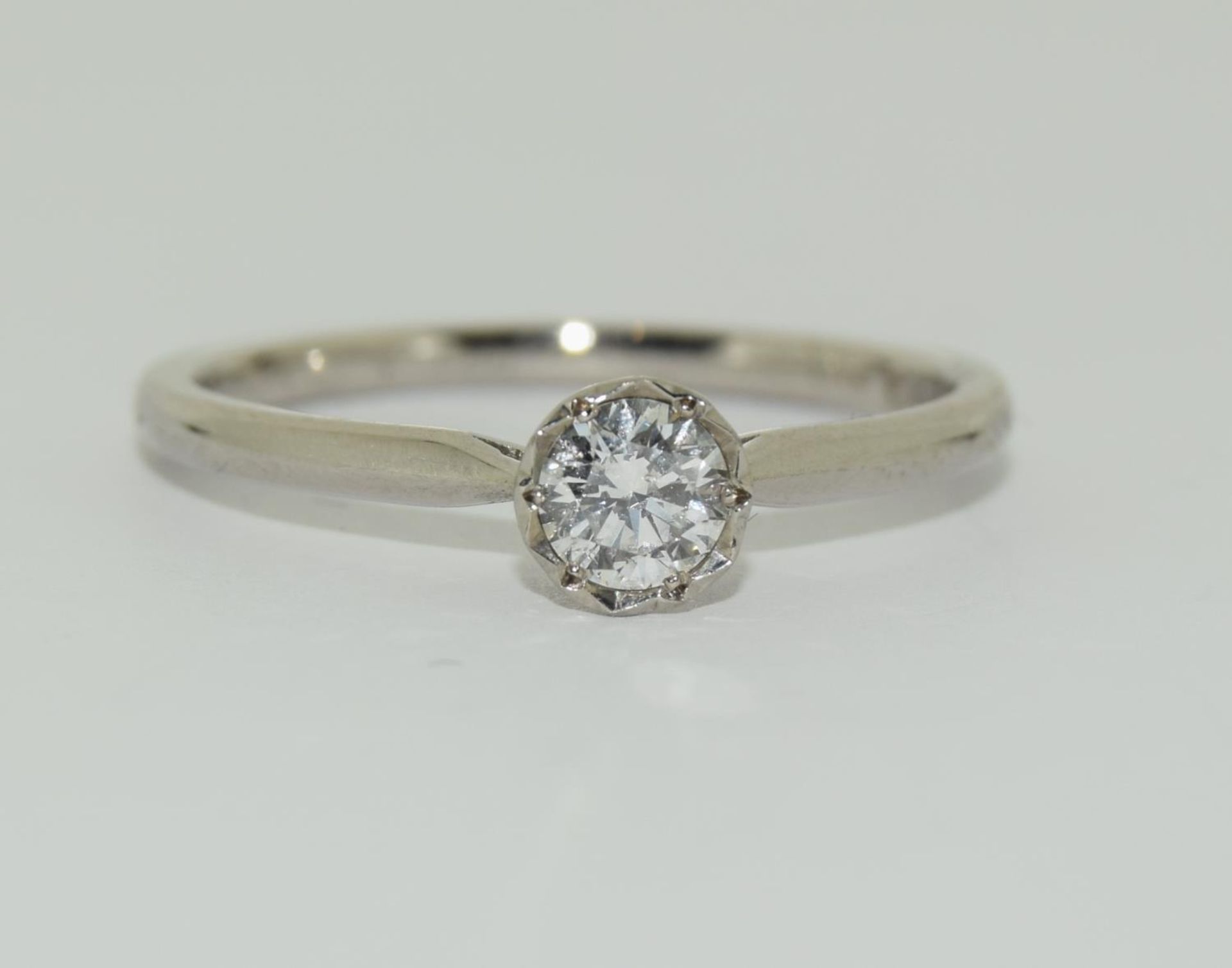 Palladium solitaire ring featuring brilliant round cut diamond in an illusion setting total