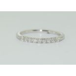 18ct white gold aura half eternity ring featuring nine uniform brilliant round cut diamonds each