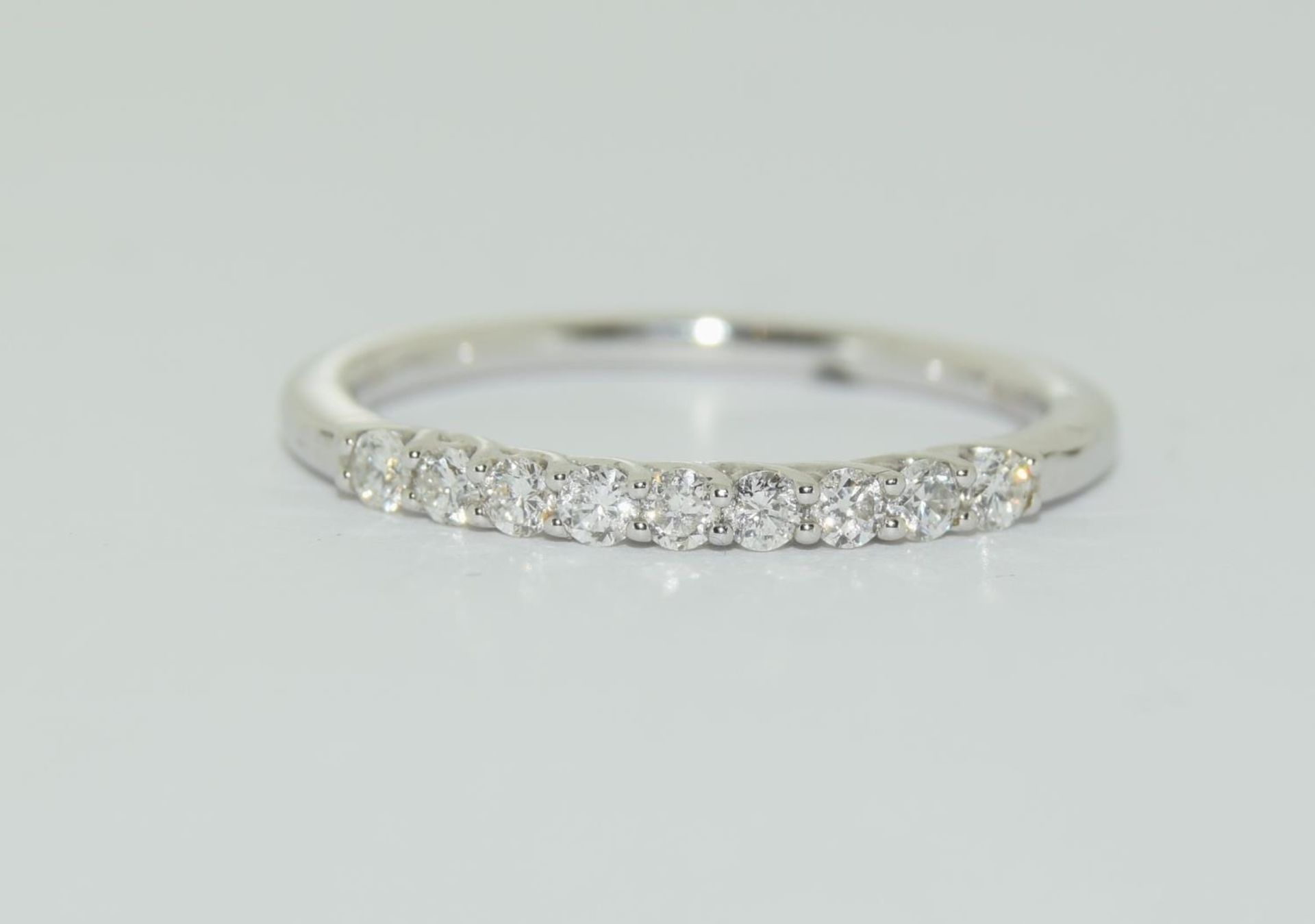 18ct white gold aura half eternity ring featuring nine uniform brilliant round cut diamonds each
