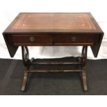 Contemporary mahogany leather top sofa table, set on bras castors and turned supports and cross