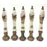 Five vintage ceramic and brass beer taps depicting images of hunting scenes.