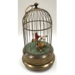 A reproduction pair of mechanical clockwork humming birds in brass cage measures 30cm tall.