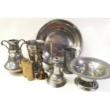 An assortment of pewter and brass items together with a mirror.
