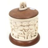 Ornately carved wooden box and cover 15cm tall overall diameter 10cm.