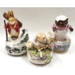 Three musical clockwork wind up Beatrix Potter figurines to include a Christmas example.