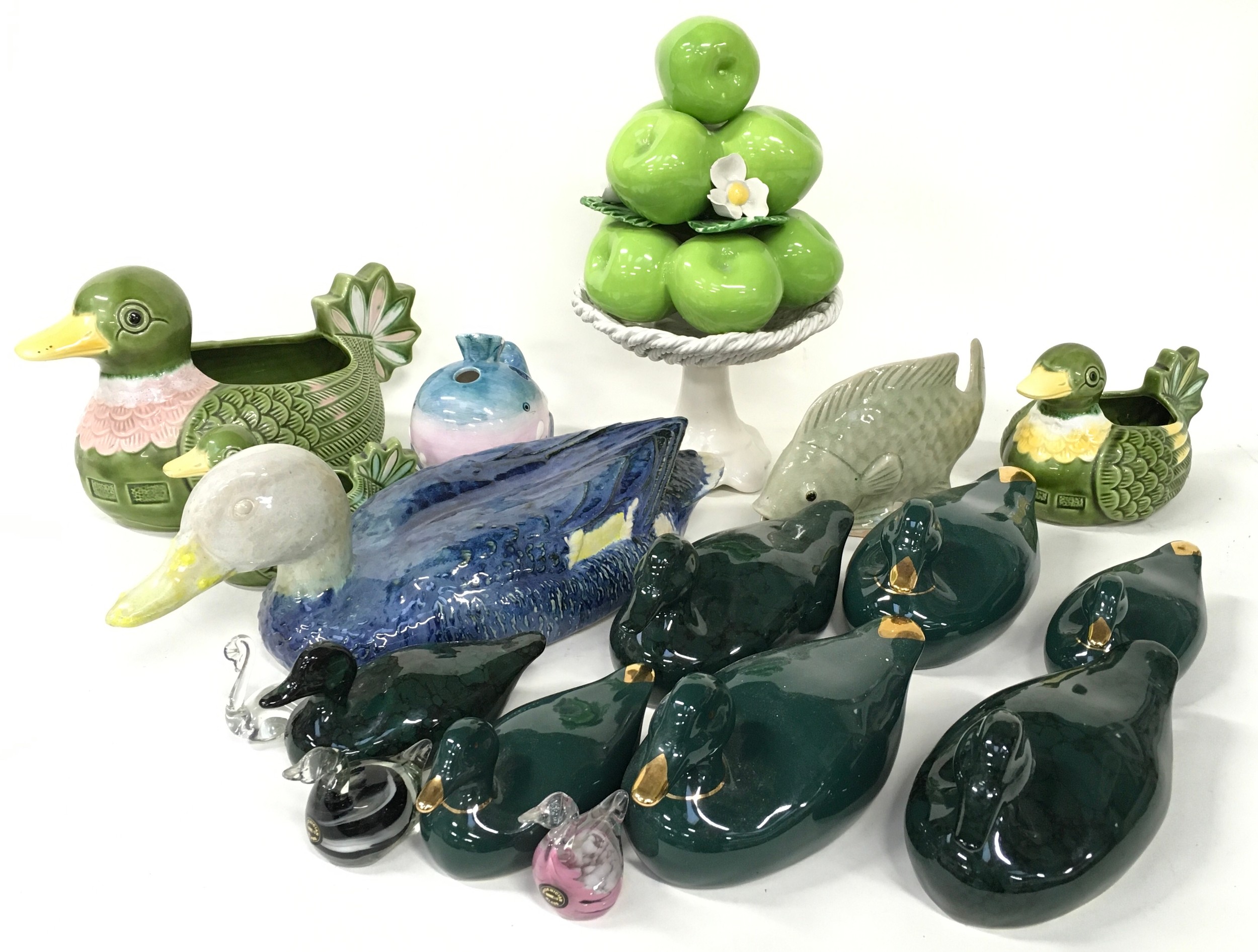 Collection of duck figurines with other ceramics.