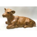 large solid wood carved figure of a calf 58cm across x 25cm tall