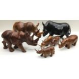 Collection of carved wooden rhinoceroses, 7 in all, the largest being 39cm across x 19cm tall
