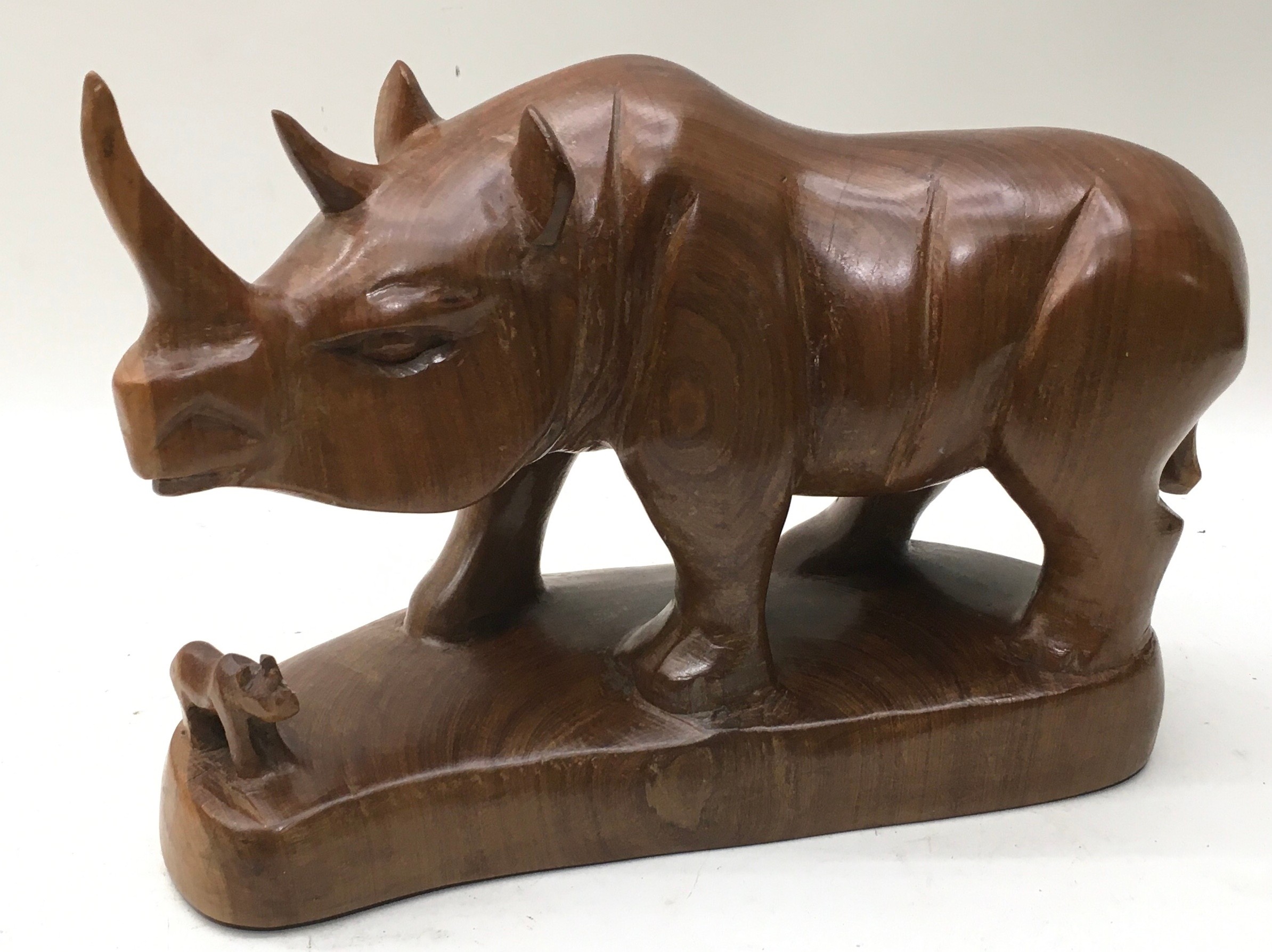 Large solid wood hand carved Rhinoceros and calf on plinth 29cm across x 20cm tall