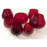 Collection of seven ruby red glass goblets.