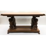 Heavy carved wood occasional / coffee table supported by elephants. 45cm tall x 90cm across