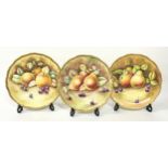 Coalport three hand painted and signed bone china fruit and gold cabinet plates each 27cm diameter.