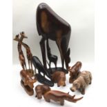 Large collection of carved wooden animals to include hippos, water buffalo, gifaffes, and a very