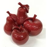 Four red porcelain large fruit sculptures, the tallest measuring 30cm.