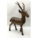 Large solid wood carved figure of a deer 37cm across x 50cm tall