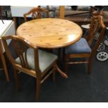Ducal pine round drop leaf kitchen table on turned supports with three matching chairs 75x90cm max