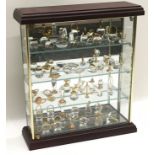 A large collection of crystal miniatures displayed in a mirrored cabinet of 3 shelves. Also includes