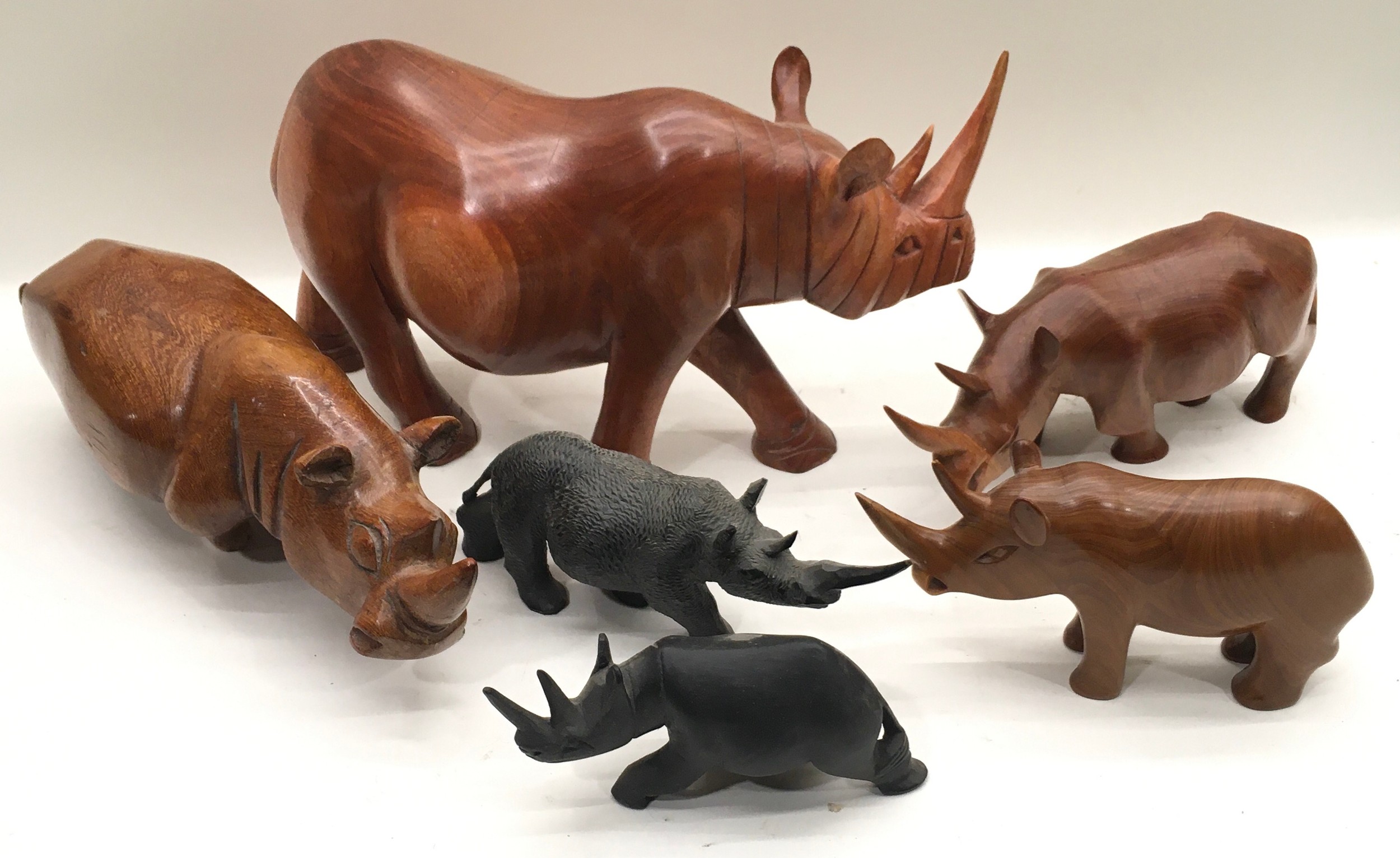 Collection of carved wooden rhinoceroses, 6 in all, the largest being 38cm across x 21cm tall - Image 2 of 2
